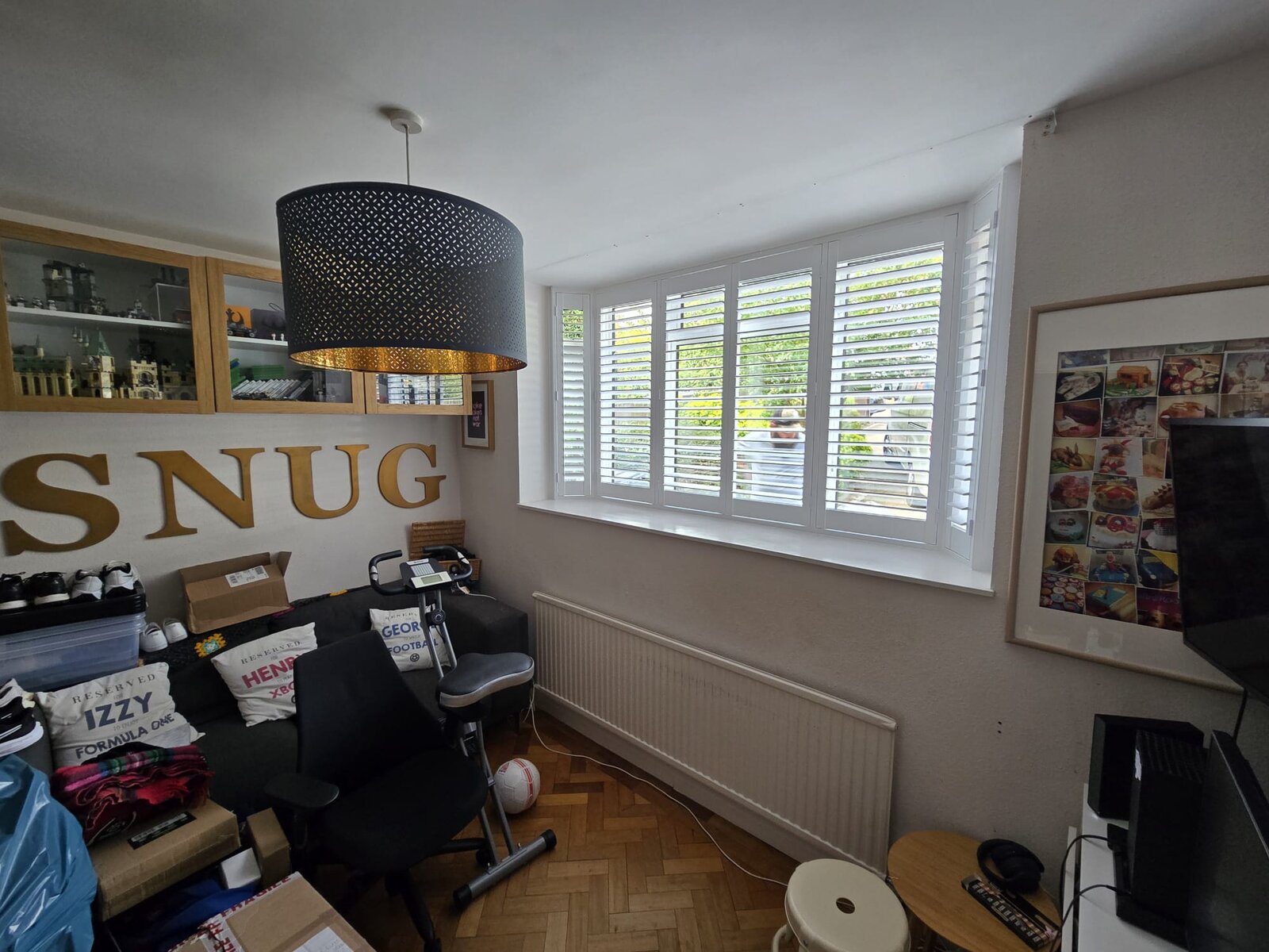 High Wycombe snug with white full-height hardwood shutters across a bay window