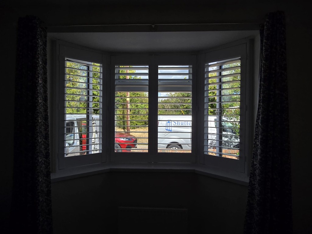 Wallingford bay window with Snow White full-height shutters open to daylight and a ShutterLab van outside