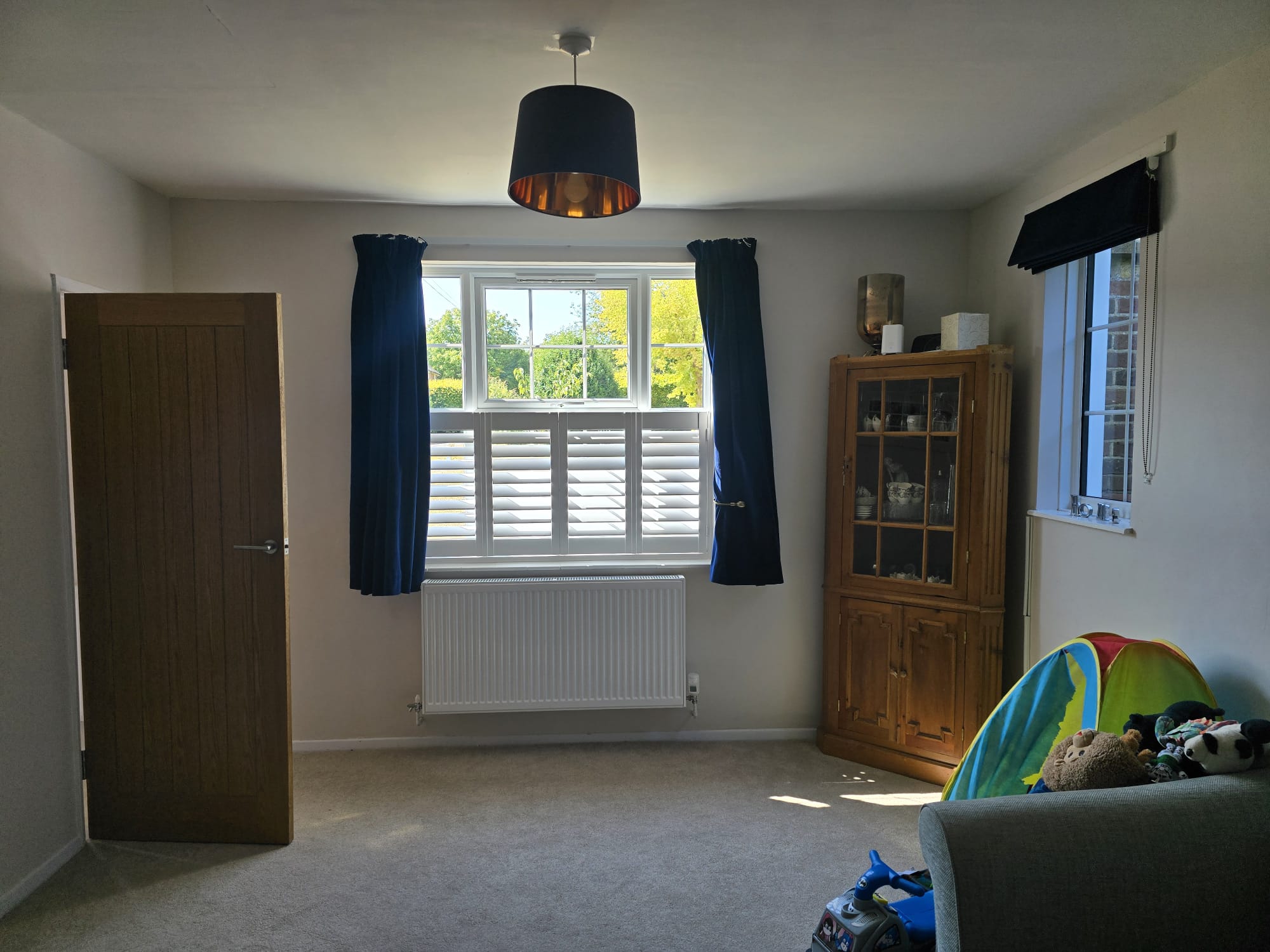 Close view of café-style hardwood shutter louvres in a Winchester living room