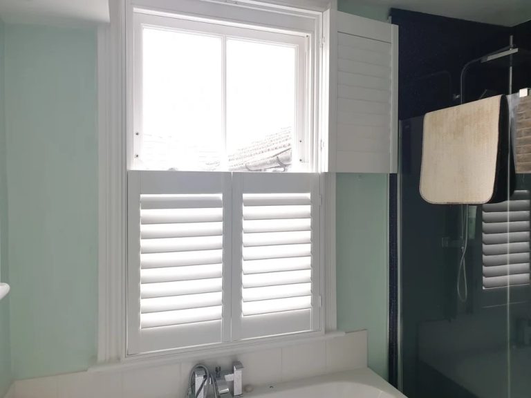 Bespoke tier-on-tier shutters fitted on a tall sash window